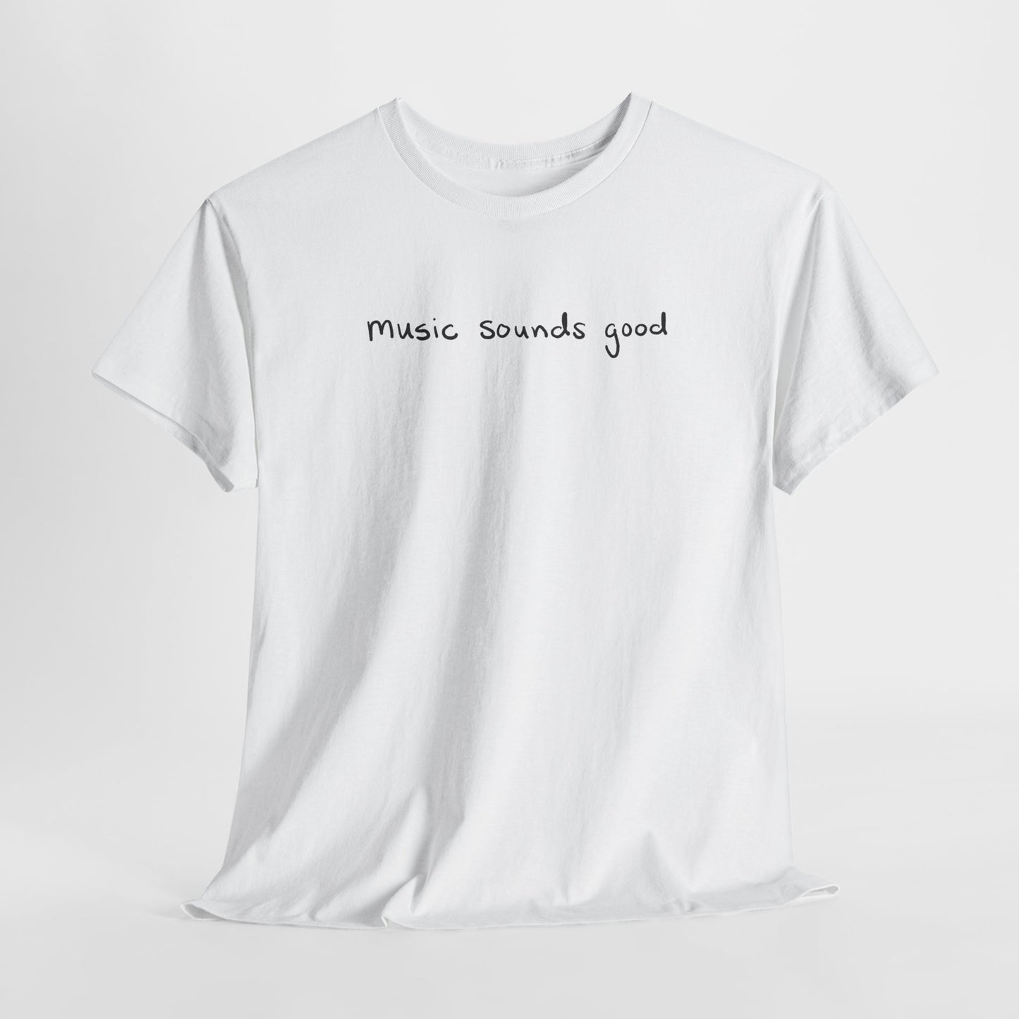 White t-shirt with 'music sounds good' text on a white background