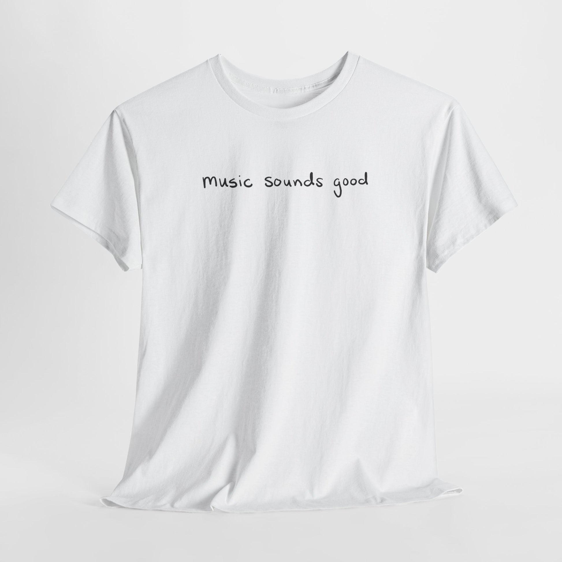 White t-shirt with 'music sounds good' text on a white background