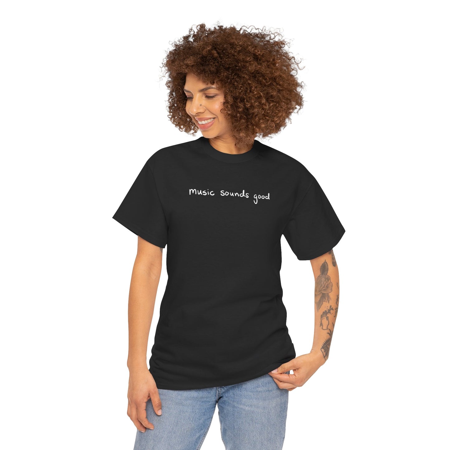 Woman wearing a black t-shirt with 'music sounds good' text on a white background