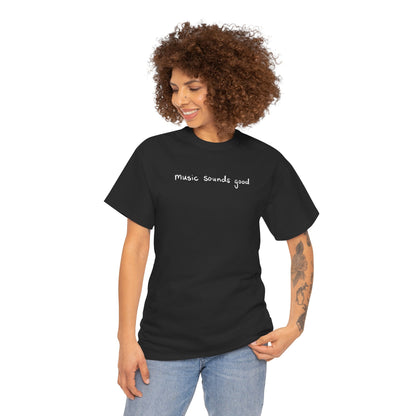 Woman wearing a black t-shirt with 'music sounds good' text on a white background
