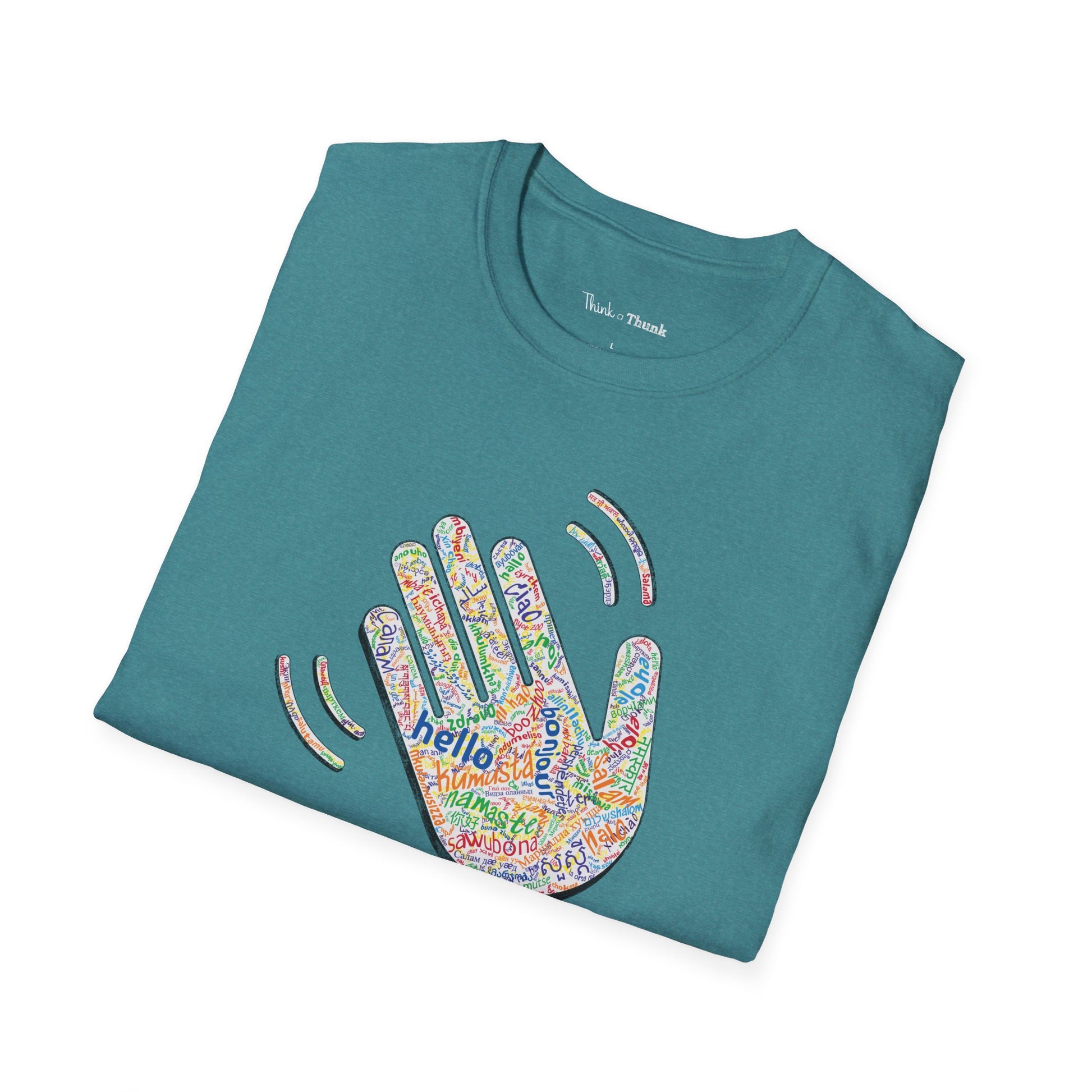 Folded teal T-shirt with a colorful hand graphic filled with greetings from many languages - on a white background