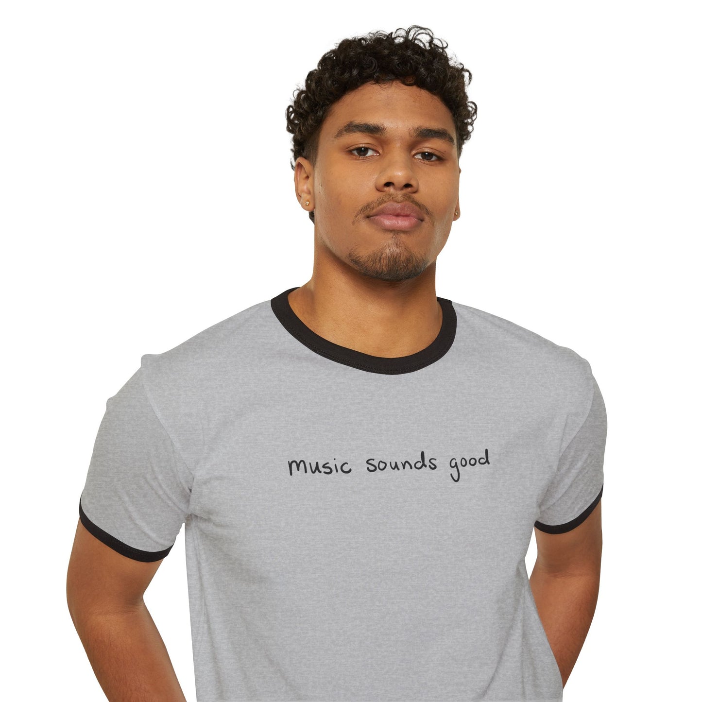 Man wearing a ringer gray t-shirt with 'music sounds good' text on a white background