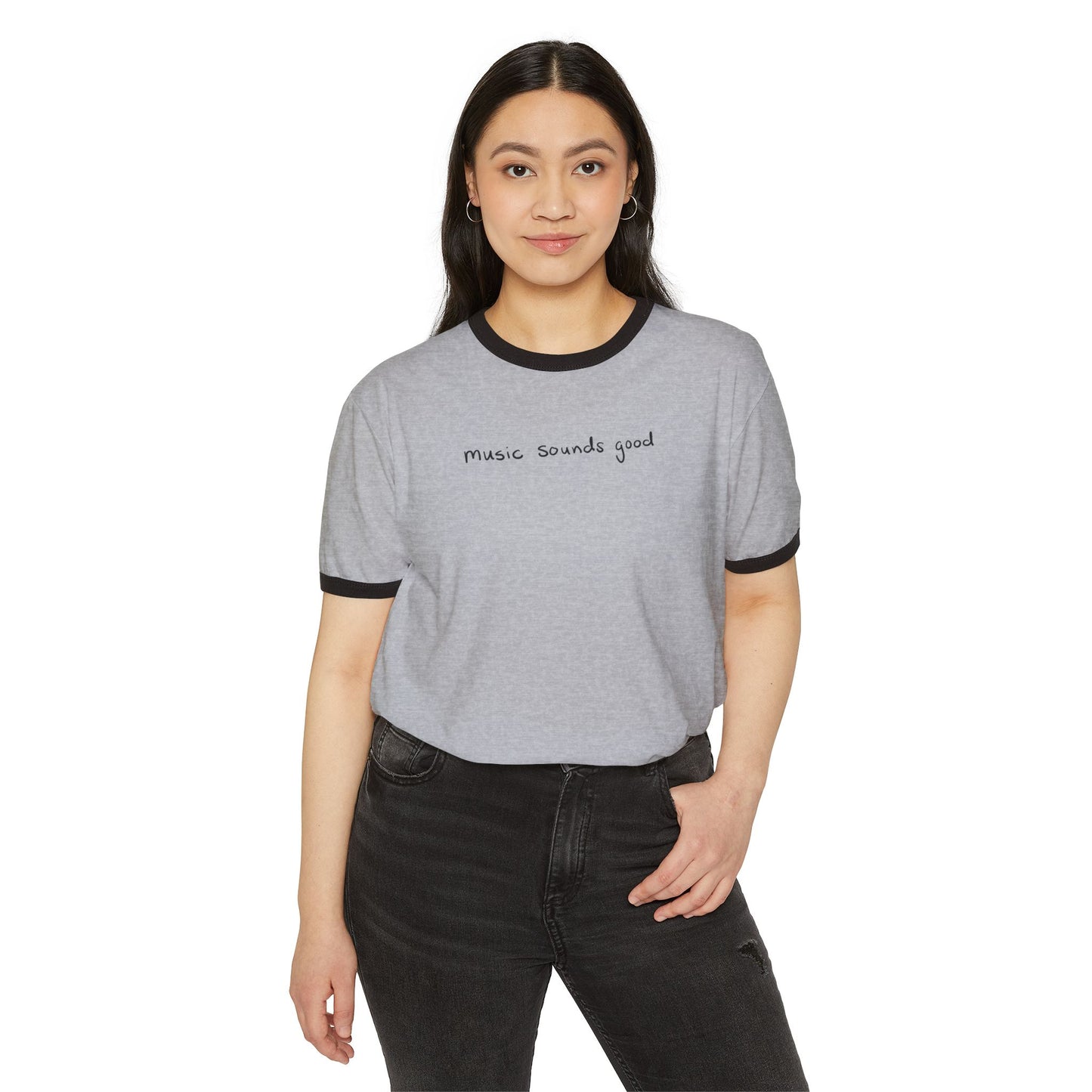 Woman wearing a gray ringer t-shirt with text 'music souunds good', on a white background