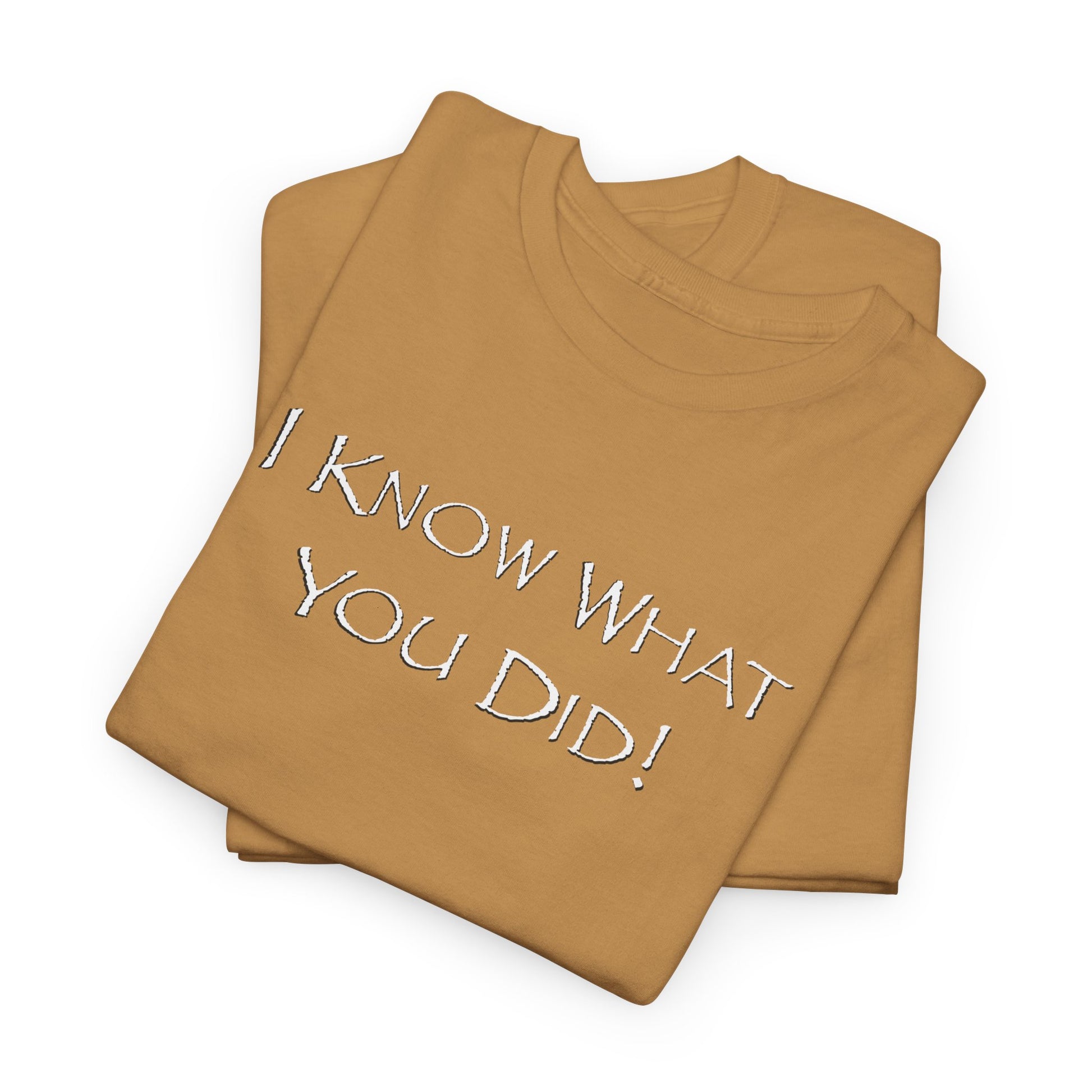 Folded old gold t-shirt with 'I KNOW WHAT YOU DID!' text on a white background