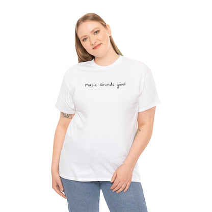 Woman wearing a white t-shirt with 'music sounds good' text on a white background