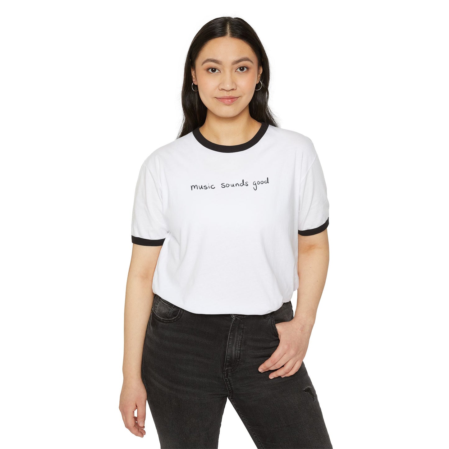 Woman wearing a white t-shirt with the text 'music souunds good' and black pants on a white background