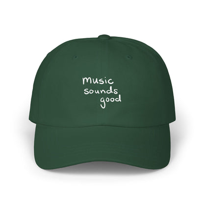 Green cap with 'music sounds good' text on a white background