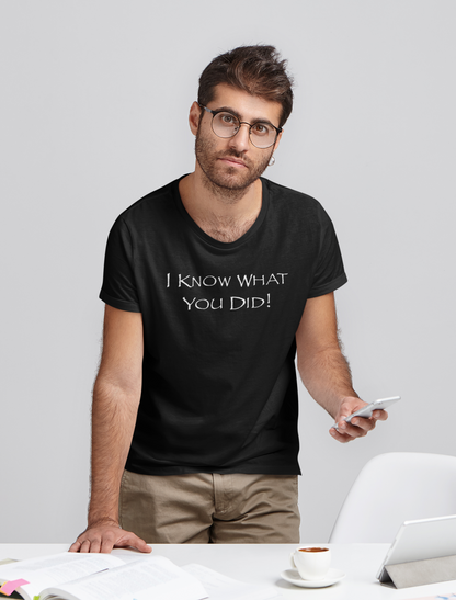 Man wearing a black t-shirt with text, standing in an office setting.