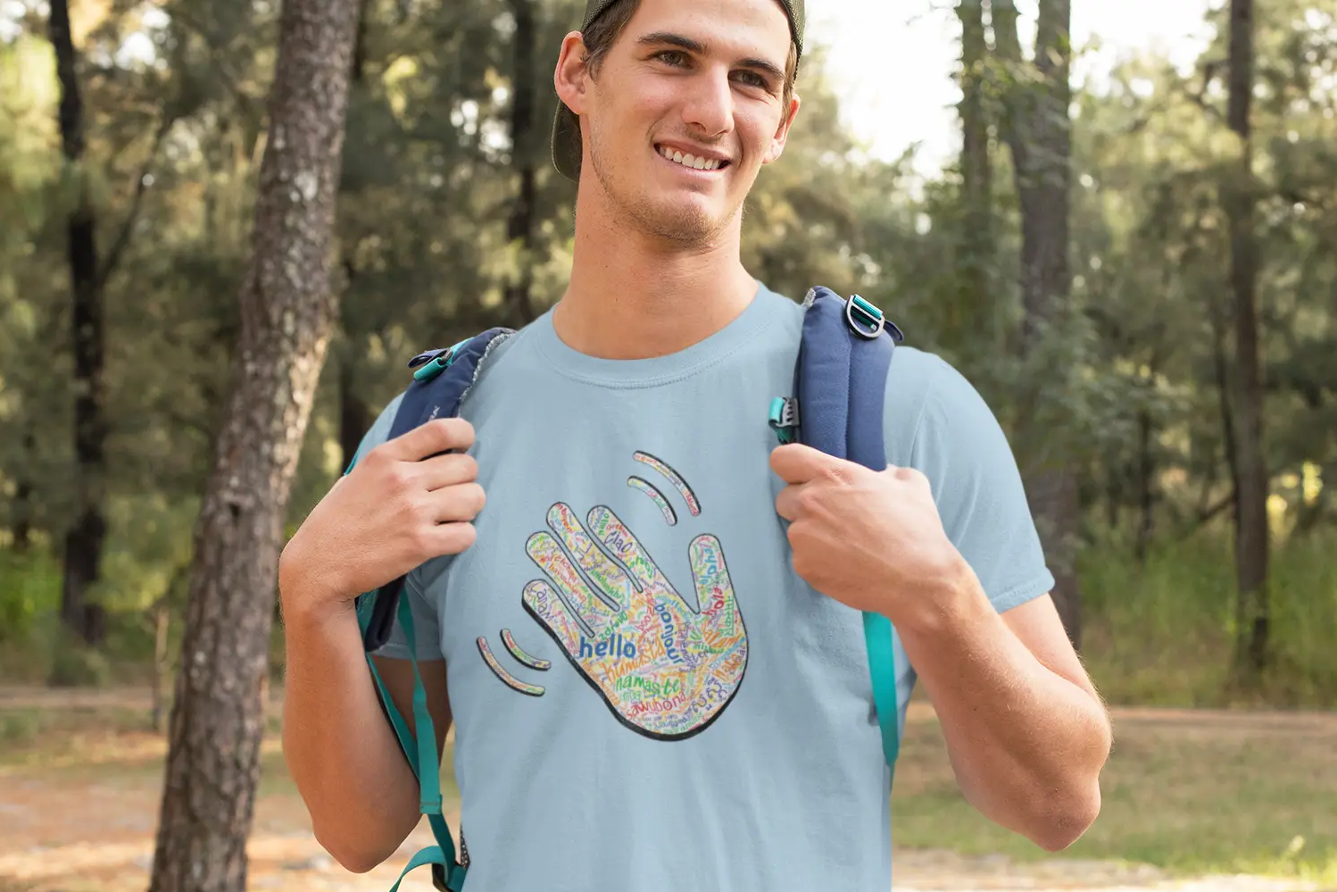 Man wearing a light blue Think a Thunk Unisex Hello T-Shirt outdoors.