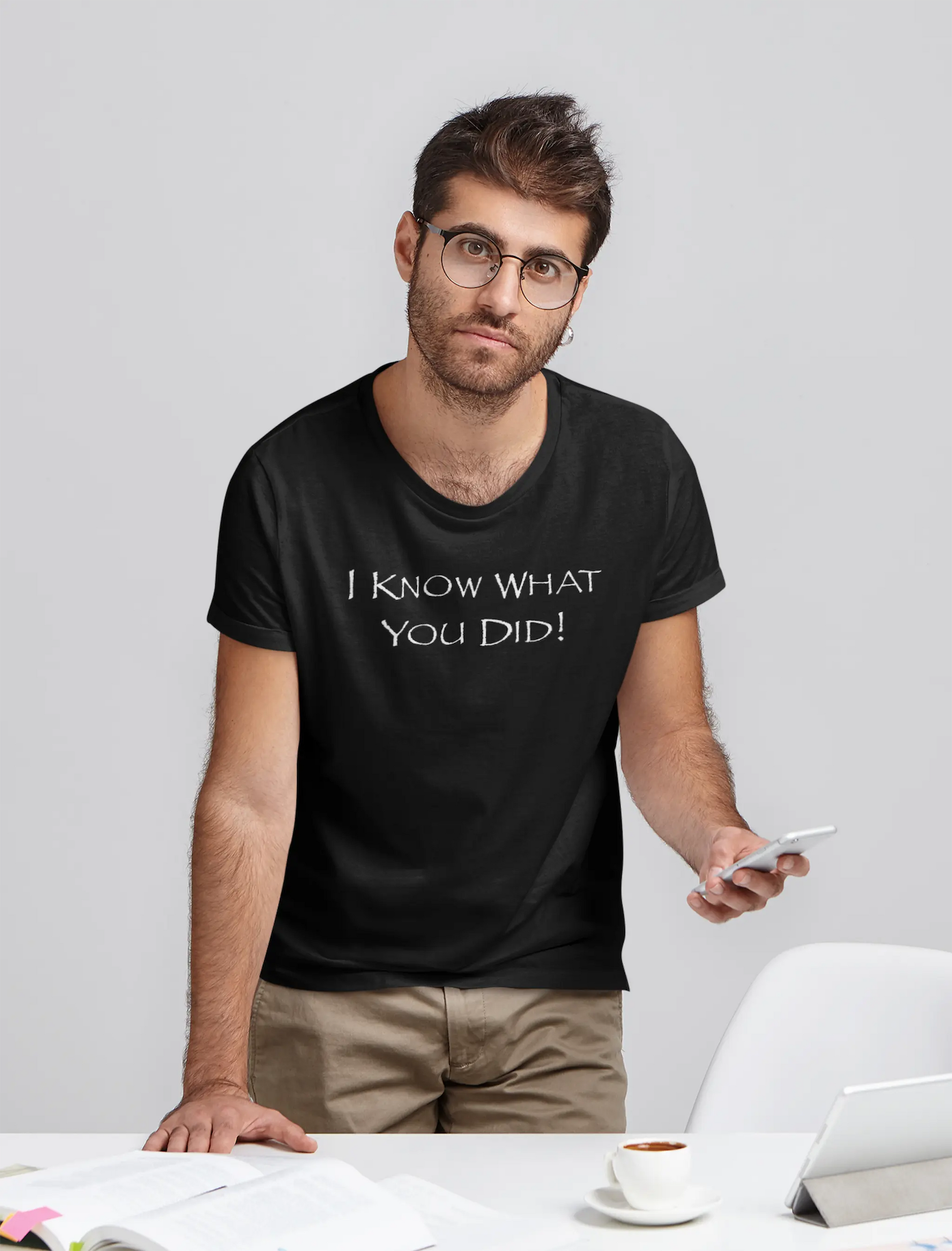 Man wearing a black Think a Thunk Unisex Papyrus Font SNL Inspired Graphic Tee standing in an office setting.