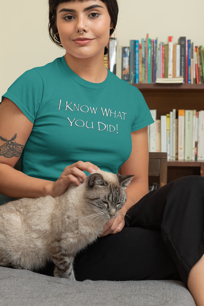 Woman wearing an antique jade Think a Thunk Unisex Papyrus Font SNL Inspired Graphic Tee, petting a cat indoors.