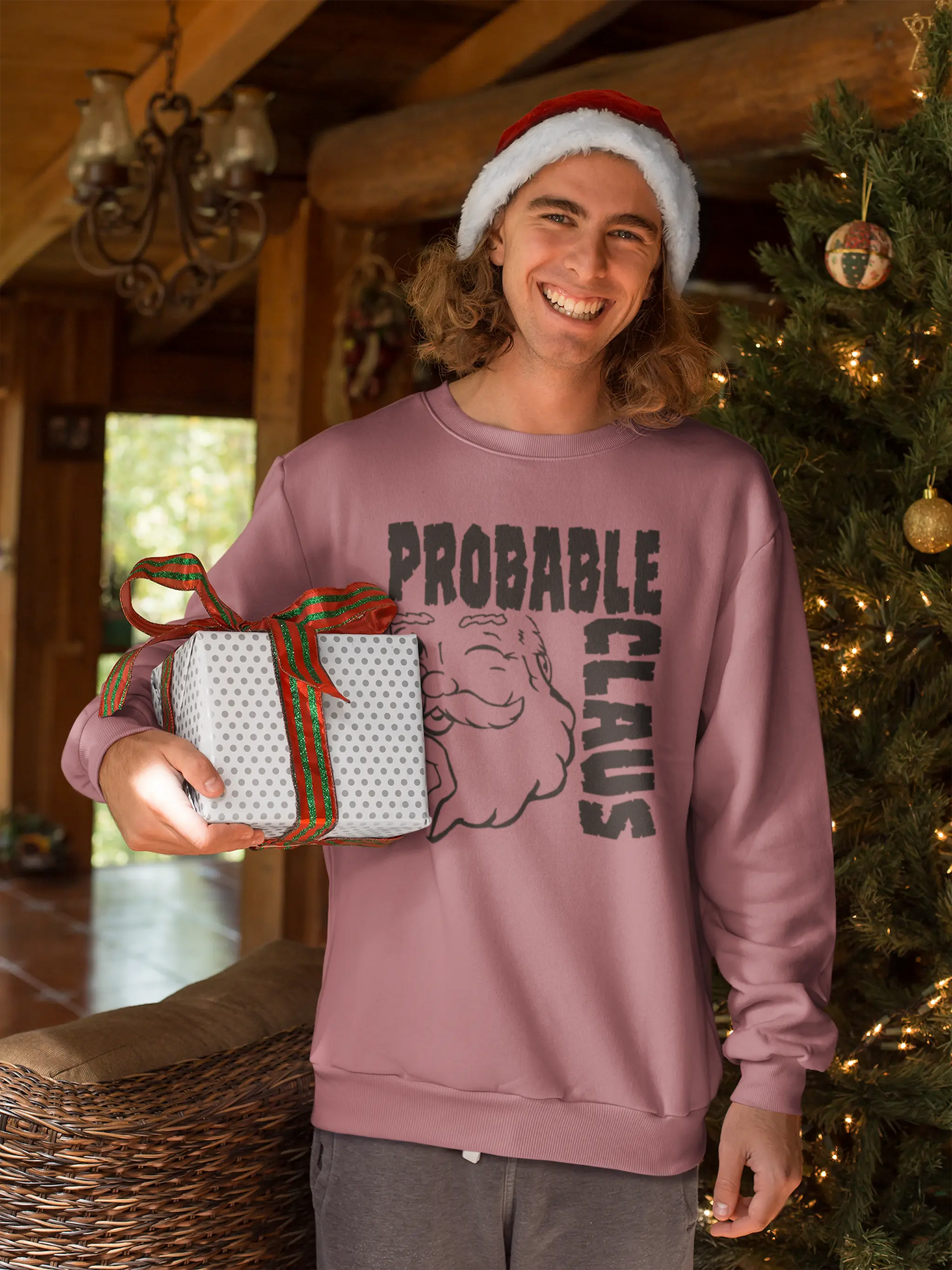 Person wearing a crimson 'Probable Claus' sweatshirt, holding a gift, in a festive setting.