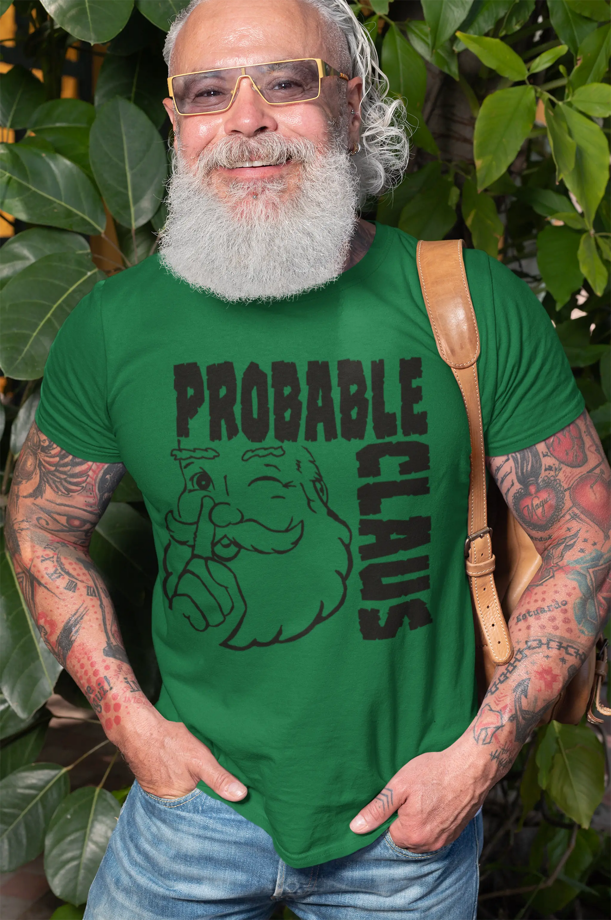 Man wearing a green t-shirt with 'Probable Claus' design outdoors.