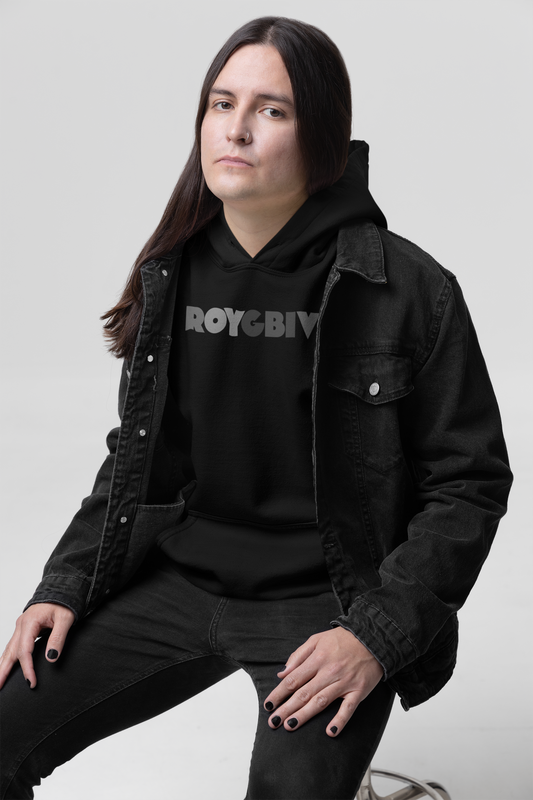Person wearing a black hoodie with 'ROYGBIV' text, sitting against a white background