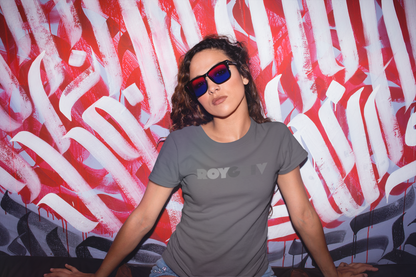 Person wearing sunglasses and a gray 'ROYGBIV' t-shirt with a red and white abstract background