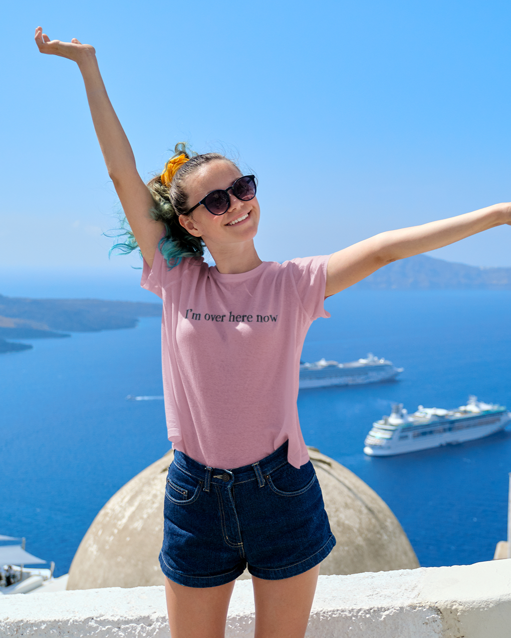 woman posing on vacation wearing I'M OVER HERE NOW T-shirt