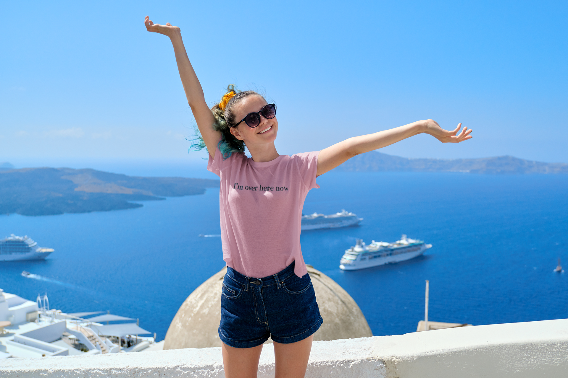 Woman with arms outstretched in front of a scenic view with boats and blue sky