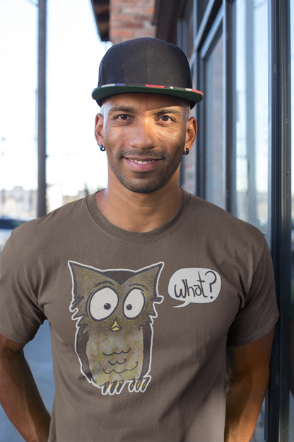 Man wearing a brown t-shirt with an owl graphic and 'What?' text, standing outdoors.